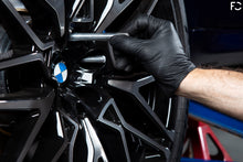 Load image into Gallery viewer, Future Classic wheel hanger pin being removed on F95 X5M after installing lug bolts