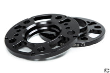 Load image into Gallery viewer, A 3/4 view of the Future Classic BMW wheel spacer machine work, pocketing, lug bolt holes, hub bolt hole provisions, and chamfered rear edges