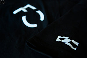 Close up view of black Future Classic t-shirt with white FC logo and sleeve flag