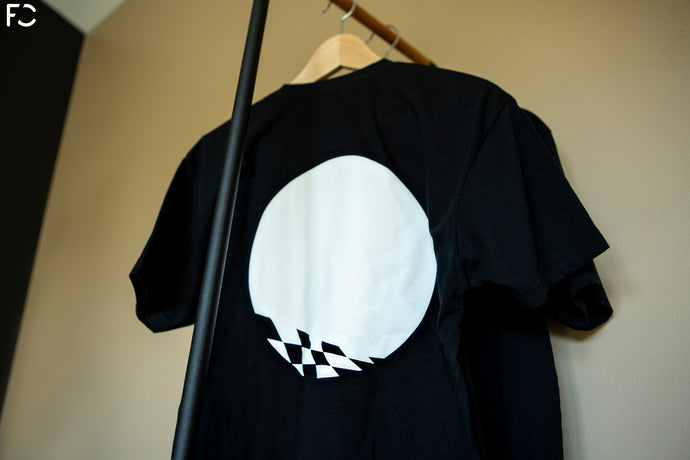 Backside low angle view of black Future Classic t-shirt with white RS meatball design